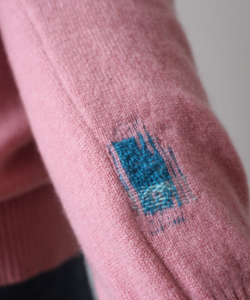 Visibly mended cashmere cardigan
