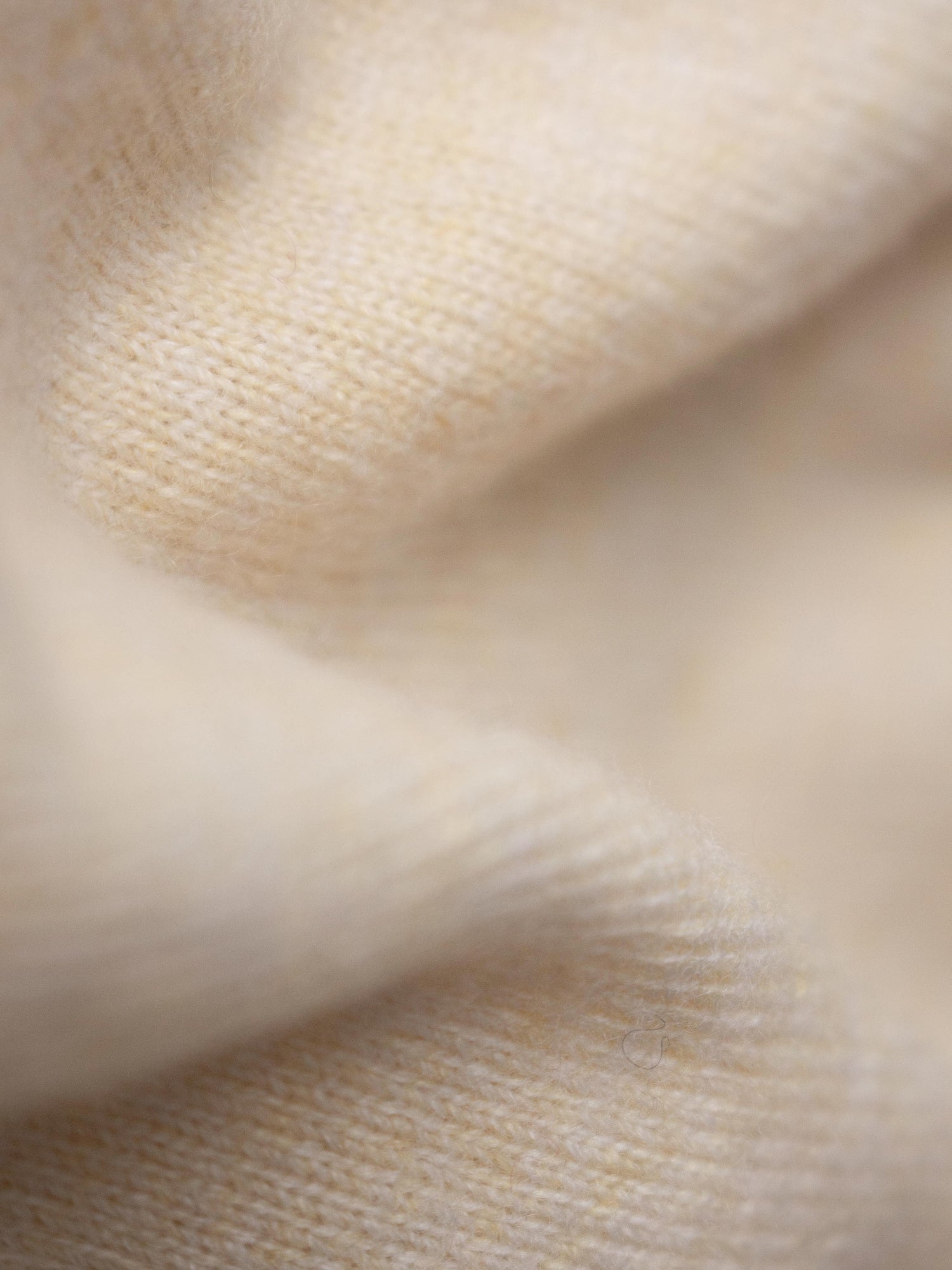 Close-up of beige cashmere fabric texture