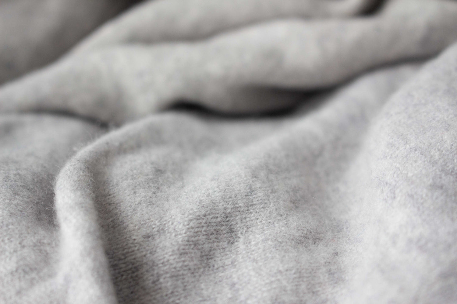 Close-up of grey cashmere fabric with folds