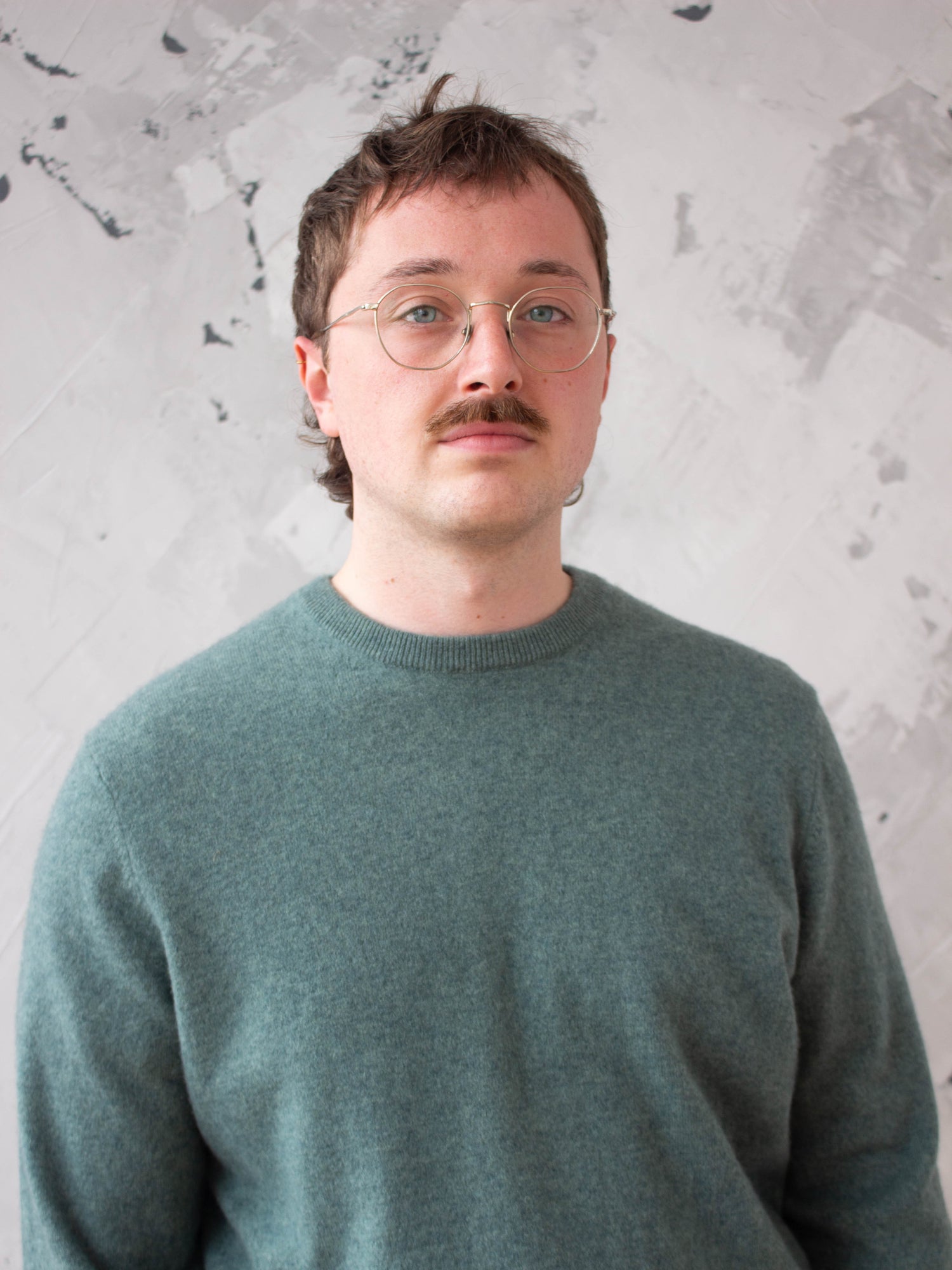Man wearing green secondhand cashmere jumper