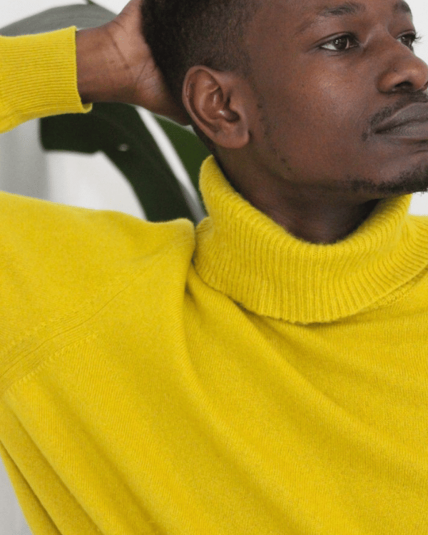 Man wearing a secondhand yellow cashmere roll neck jumper