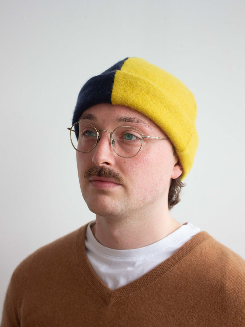 Man wearing blue and yellow cashmere beanie