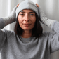 Woman wearing reclaimed cashmere beanie hat and cashmere fingerless gloves.