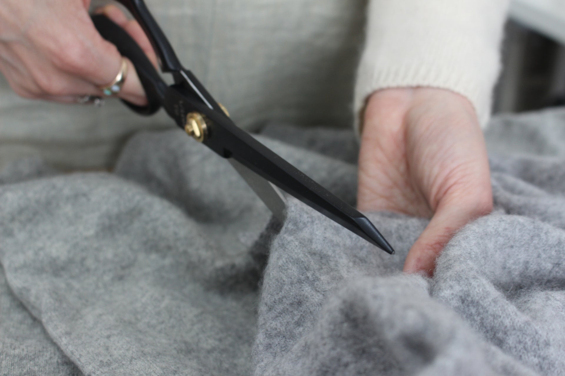Woman cutting cashmere fabric