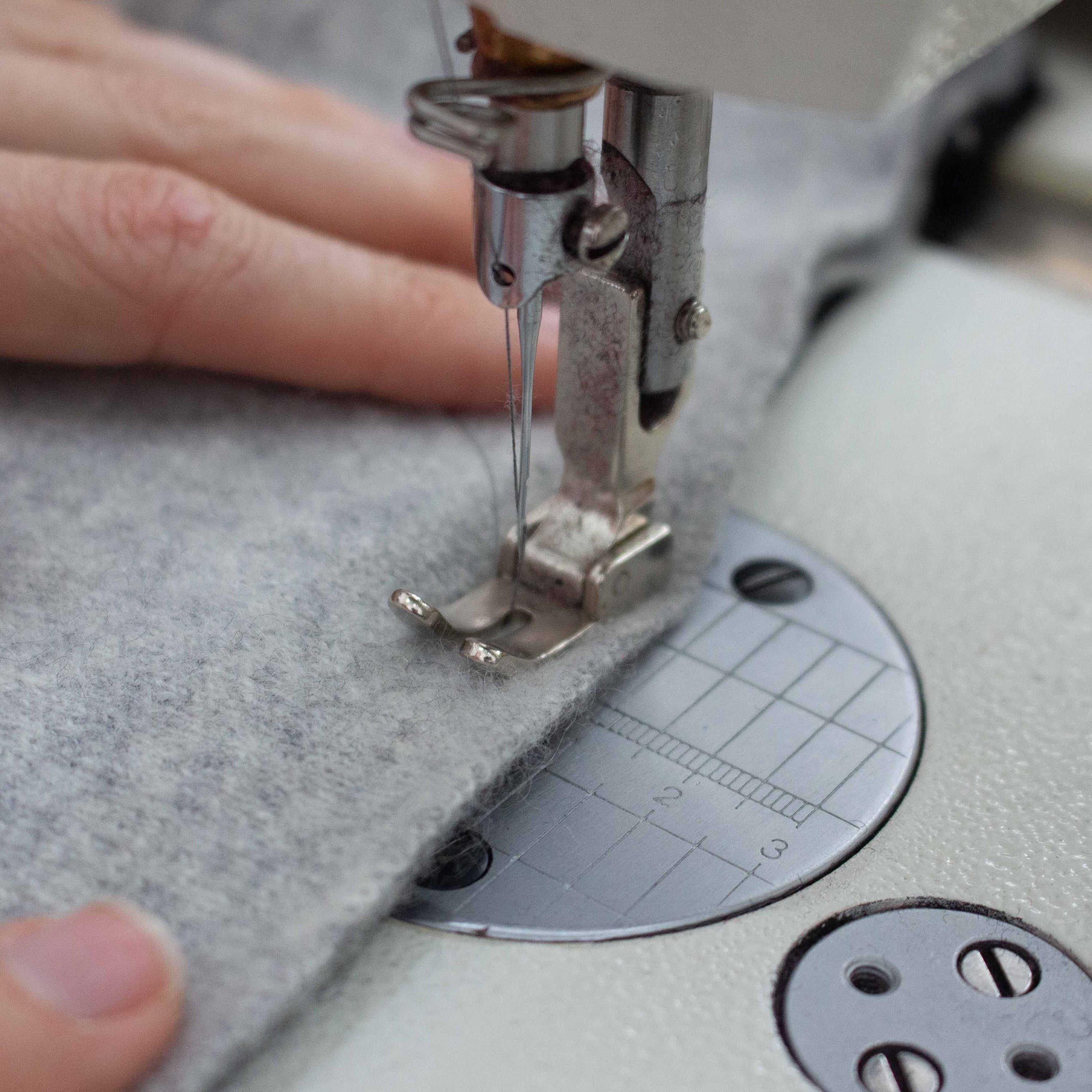 Woman sewing cashmere fabric