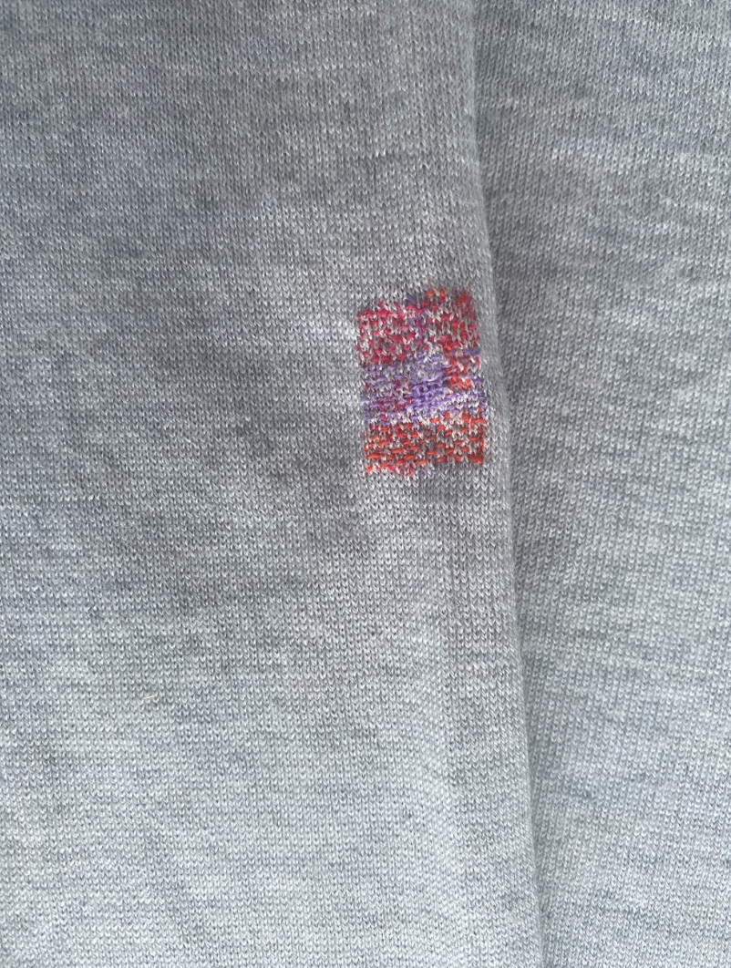 A visible mend on a cashmere jumper