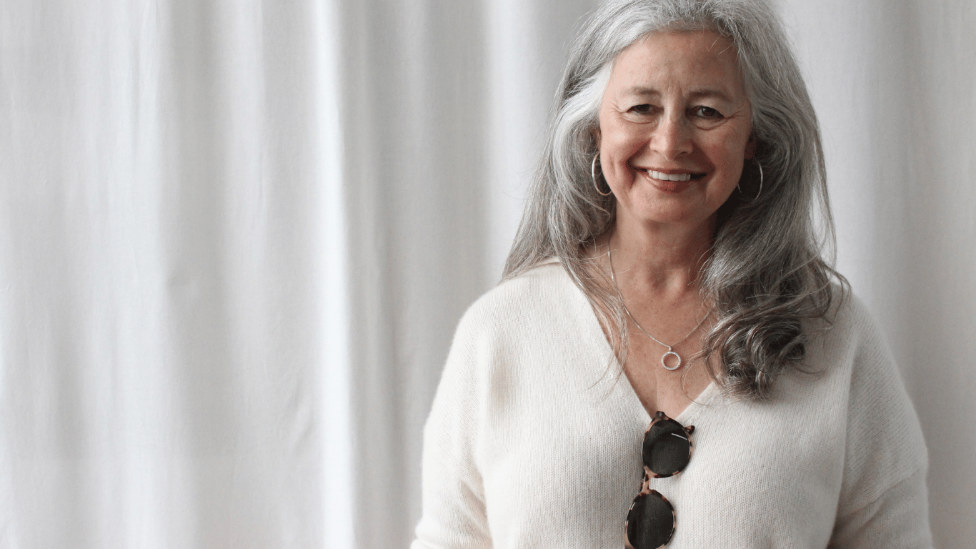 Woman wearing white secondhand cashmere jumper
